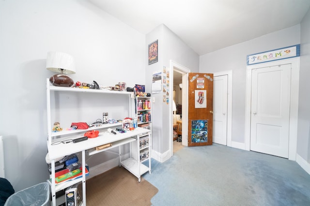 office space featuring baseboards and light colored carpet