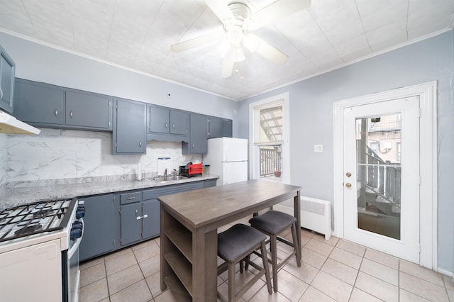 kitchen with ornamental molding, light tile patterned flooring, white appliances, tasteful backsplash, and a ceiling fan