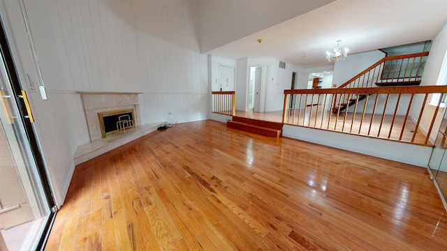 602 Sanderling Ct Unit 602, Secaucus, NJ 07094 - unfurnished living room featuring a premium fireplace, stairs, a notable chandelier, and wood-type flooring