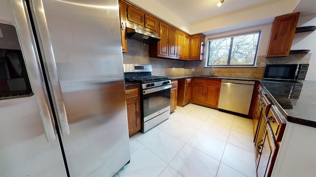 602 Sanderling Ct Unit 602, Secaucus, NJ 07094 - kitchen featuring under cabinet range hood, stainless steel appliances, tasteful backsplash, and brown cabinets