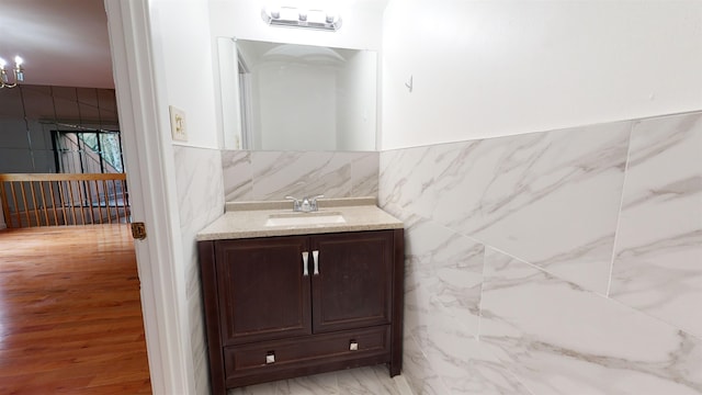 602 Sanderling Ct Unit 602, Secaucus, NJ 07094 - bathroom with vanity, tile walls, a notable chandelier, and a wainscoted wall