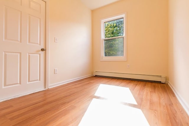 69 Belmont Ave, Jersey City, NJ 07304 - unfurnished room with a baseboard heating unit, light wood-style floors, and baseboards