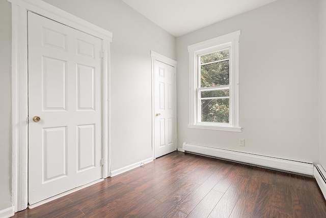 69 Belmont Ave, Jersey City, NJ 07304 - unfurnished bedroom featuring dark wood-type flooring, baseboards, and a baseboard radiator