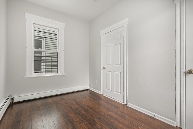 69 Belmont Ave, Jersey City, NJ 07304 - spare room featuring dark wood finished floors, a baseboard heating unit, and baseboards