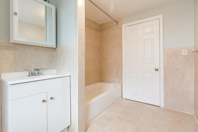 69 Belmont Ave, Jersey City, NJ 07304 - full bathroom featuring tile walls, vanity, bathing tub / shower combination, tile patterned flooring, and wainscoting