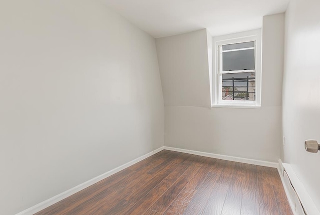69 Belmont Ave, Jersey City, NJ 07304 - unfurnished room featuring a baseboard radiator, dark wood-style flooring, and baseboards