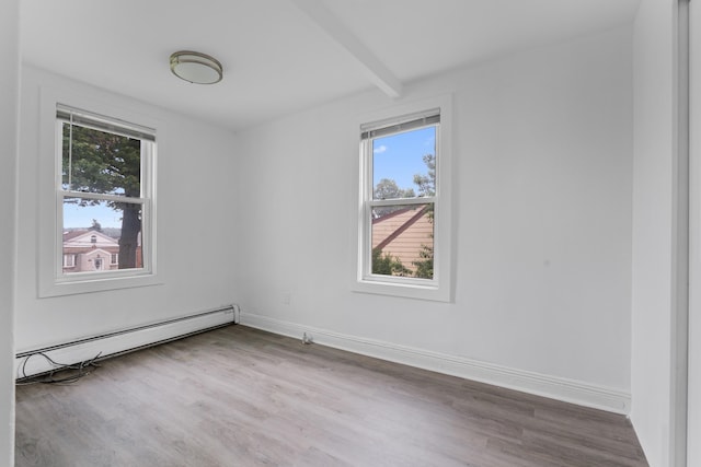 51 Lord Ave, Bayonne, NJ 07002 - unfurnished room with healthy amount of natural light, baseboard heating, wood finished floors, and beam ceiling