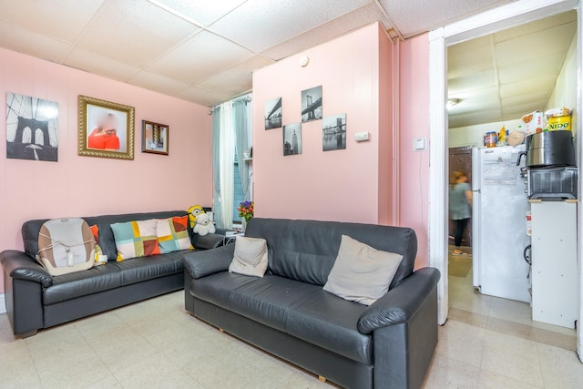 living room with a paneled ceiling