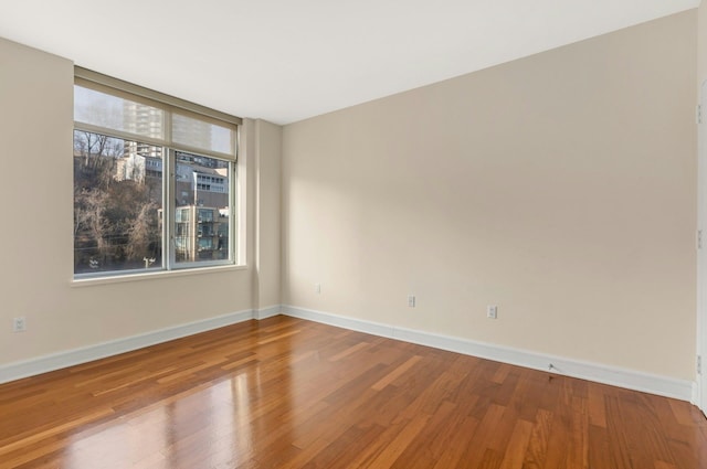 spare room with hardwood / wood-style floors