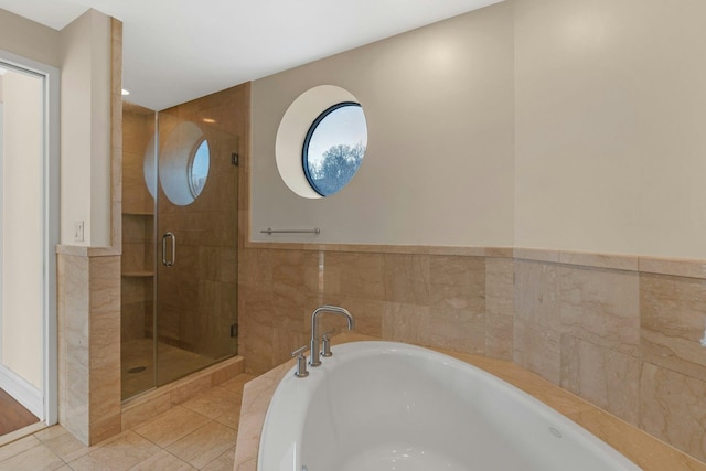 bathroom featuring plus walk in shower and tile patterned floors