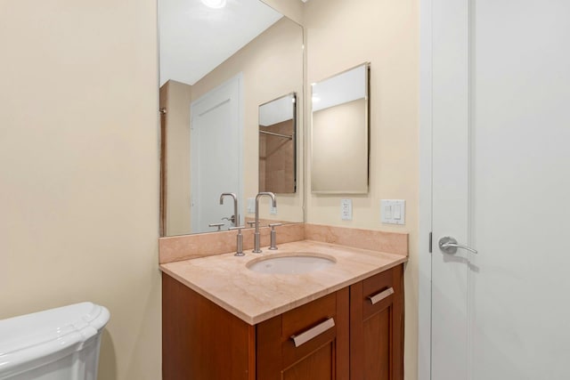 bathroom with vanity and toilet