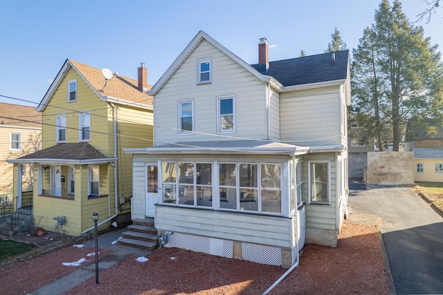 view of front of home featuring a sunroom