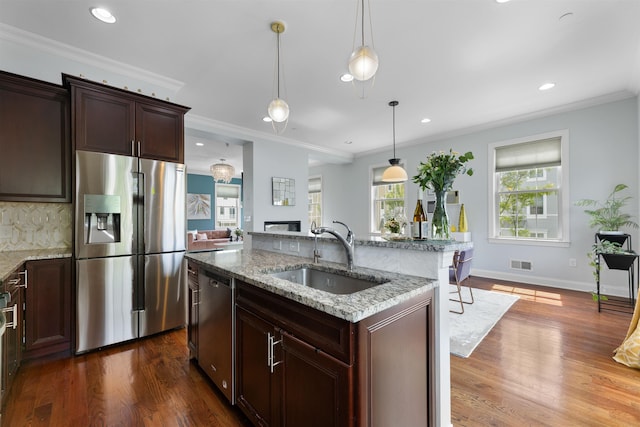 129 Roosevelt Dr, Wood-Ridge, NJ 07075 - kitchen with appliances with stainless steel finishes, a sink, dark wood-style flooring, light stone countertops, and ornamental molding