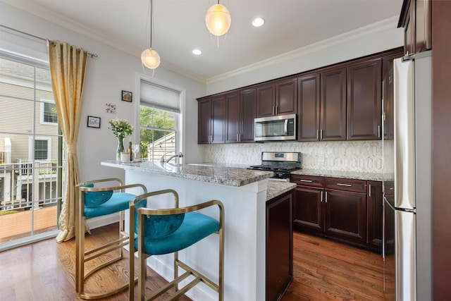 129 Roosevelt Dr, Wood-Ridge, NJ 07075 - kitchen with appliances with stainless steel finishes, tasteful backsplash, dark wood finished floors, hanging light fixtures, and crown molding