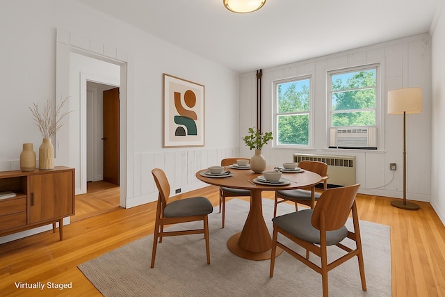 110 56th St, West New York, NJ 07093 - dining area with radiator, light wood-style flooring, and cooling unit