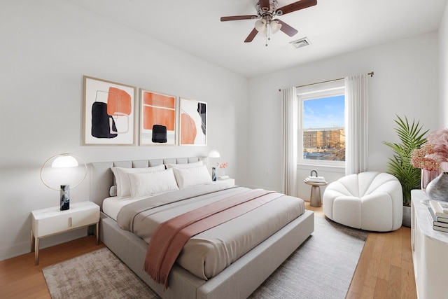 bedroom with ceiling fan and light hardwood / wood-style floors