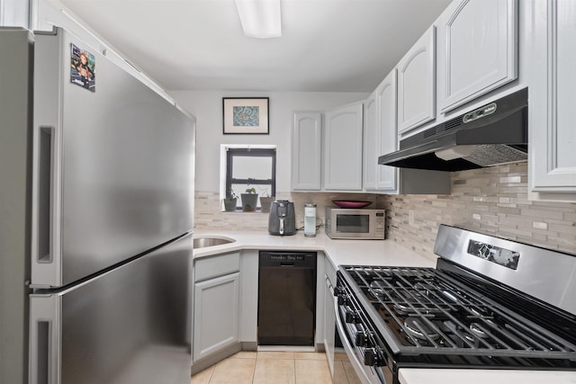 kitchen featuring white cabinets, stainless steel appliances, sink, backsplash, and light tile patterned floors