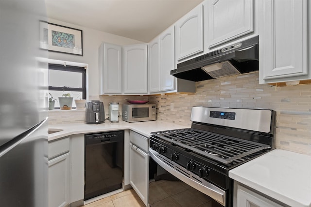 kitchen with light tile patterned floors, backsplash, white cabinets, and stainless steel appliances