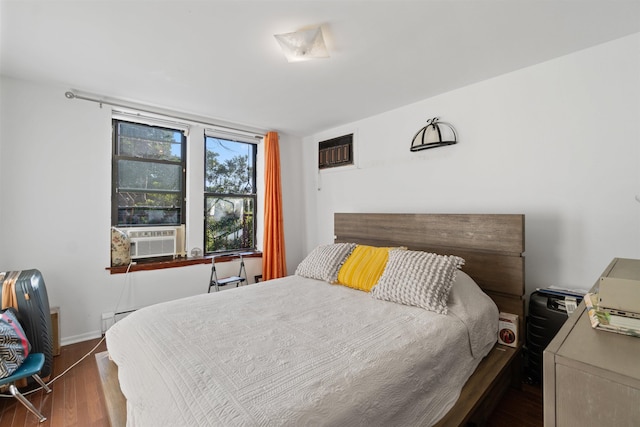 bedroom with dark hardwood / wood-style flooring and cooling unit