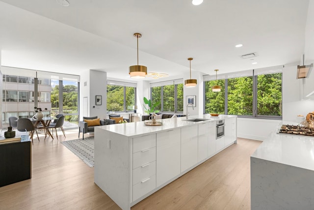 9 Ave At Port Imperial # 524, West New York, NJ 07093 - kitchen with modern cabinets, a sink, light countertops, stainless steel appliances, and white cabinets