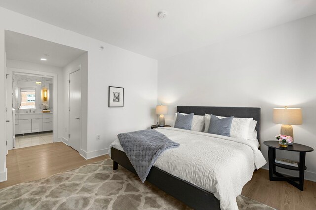 9 Ave At Port Imperial # 524, West New York, NJ 07093 - bedroom with wood finished floors, baseboards, and connected bathroom