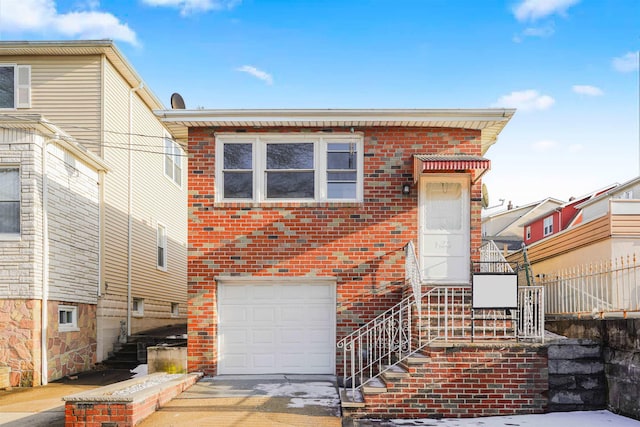 8408 Grand Ave, North Bergen, NJ 07047 - view of front of house with an attached garage, stairway, brick siding, and driveway