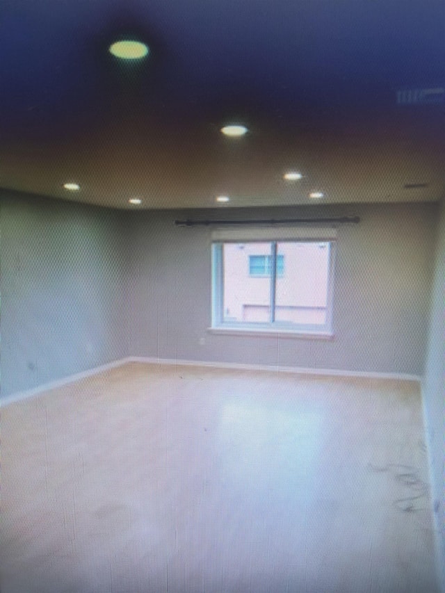 empty room with recessed lighting and wallpapered walls