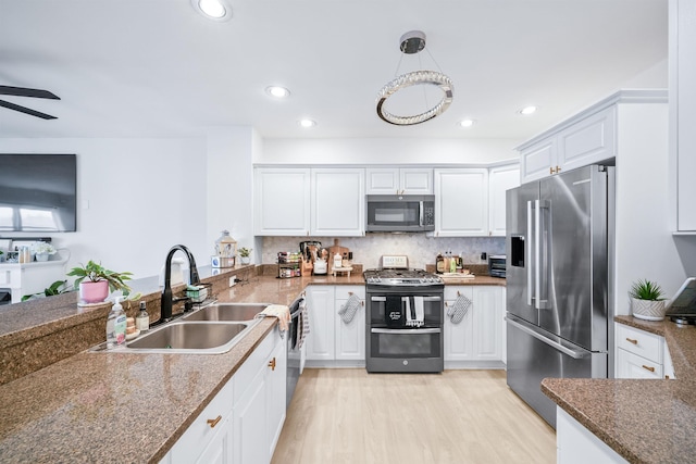 319 The Promenade, Edgewater, NJ 07020 - kitchen featuring stainless steel appliances, light wood-style flooring, white cabinetry, a peninsula, and a ceiling fan