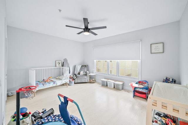 319 The Promenade, Edgewater, NJ 07020 - bedroom featuring wood finished floors, a ceiling fan, and a nursery area