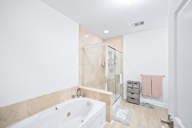 319 The Promenade, Edgewater, NJ 07020 - bathroom with a jetted tub, a stall shower, and wood finished floors