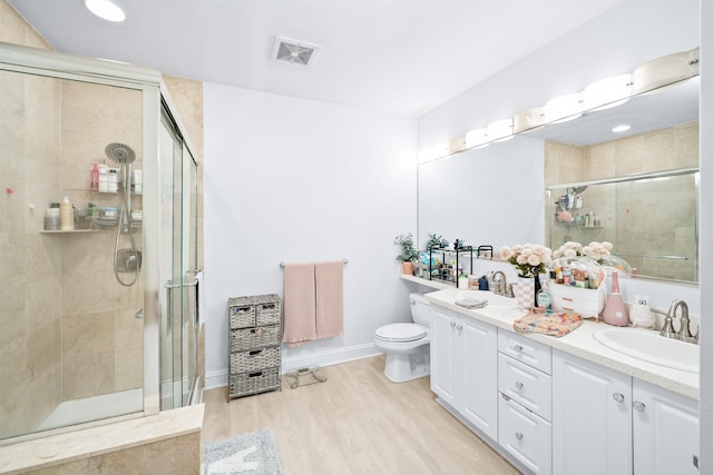 319 The Promenade, Edgewater, NJ 07020 - bathroom featuring a stall shower, double vanity, and wood finished floors