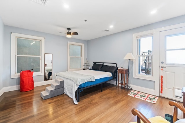 bedroom with hardwood / wood-style floors and ceiling fan