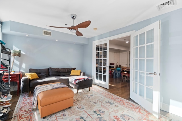 living room featuring french doors, ceiling fan, and wood-type flooring