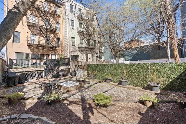 607 1st St Unit 2F, Hoboken, NJ 07030 - view of yard with a wooden deck and fence