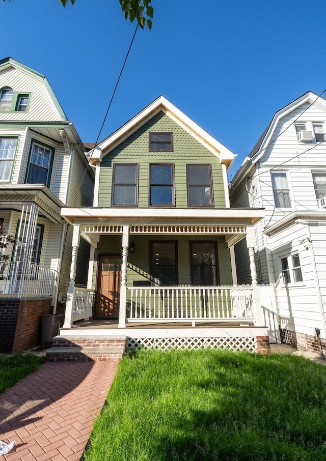 247 Harrison Ave Unit 1, Jersey City, NJ 07304 - view of front of home with covered porch and a front yard