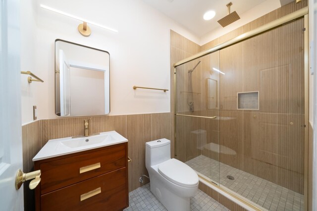 247 Harrison Ave Unit 1, Jersey City, NJ 07304 - bathroom with a wainscoted wall, a stall shower, vanity, and tile patterned floors