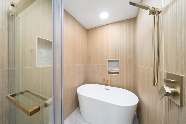 247 Harrison Ave Unit 1, Jersey City, NJ 07304 - full bathroom with a freestanding bath, tile patterned floors, a shower, and tile walls