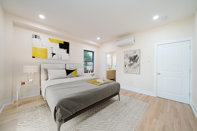 247 Harrison Ave Unit 1, Jersey City, NJ 07304 - bedroom with a wall mounted air conditioner, light wood-style floors, recessed lighting, and connected bathroom