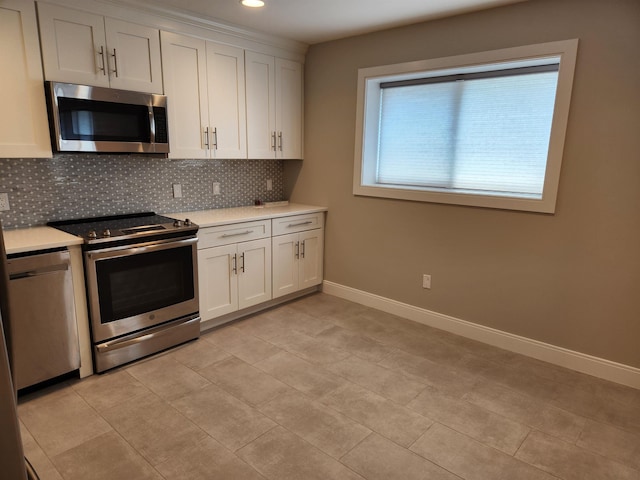 86 W 33rd St Unit 207, Bayonne, NJ 07002 - kitchen with stainless steel appliances, tasteful backsplash, light countertops, white cabinetry, and recessed lighting
