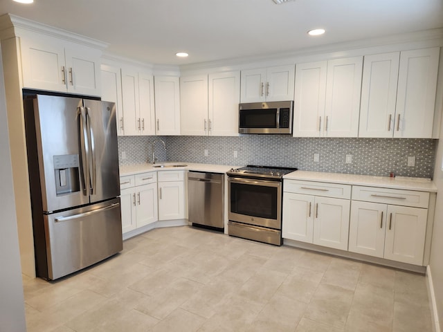 86 W 33rd St Unit 207, Bayonne, NJ 07002 - kitchen with appliances with stainless steel finishes, light countertops, white cabinets, decorative backsplash, and recessed lighting