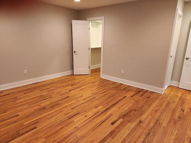 86 W 33rd St Unit 207, Bayonne, NJ 07002 - unfurnished bedroom featuring light wood finished floors and a walk in closet