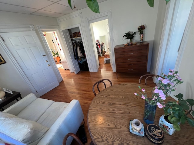 dining room with a paneled ceiling and hardwood / wood-style floors