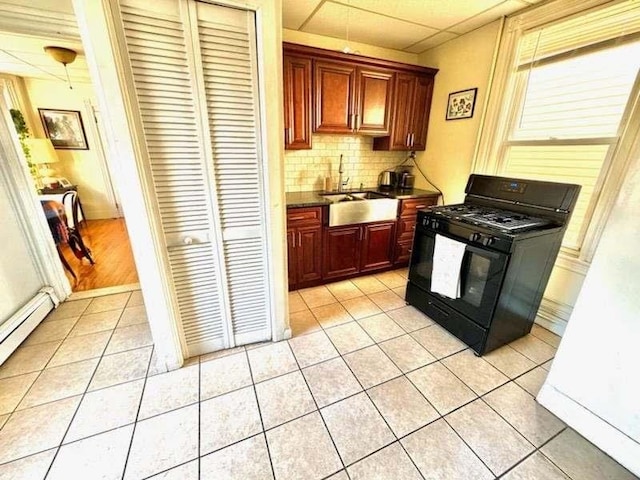 kitchen with sink, black range with gas cooktop, and light tile patterned floors