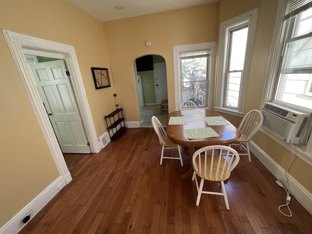 dining room with cooling unit and dark hardwood / wood-style flooring