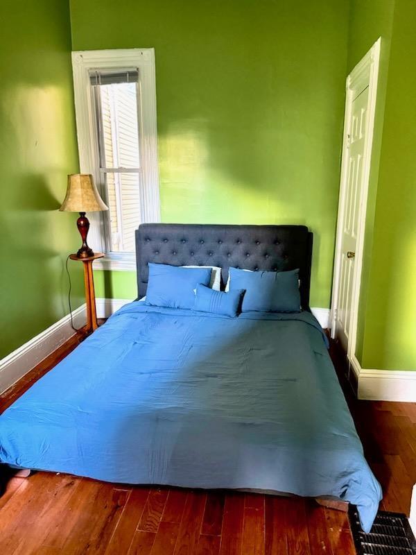 bedroom featuring dark wood-type flooring