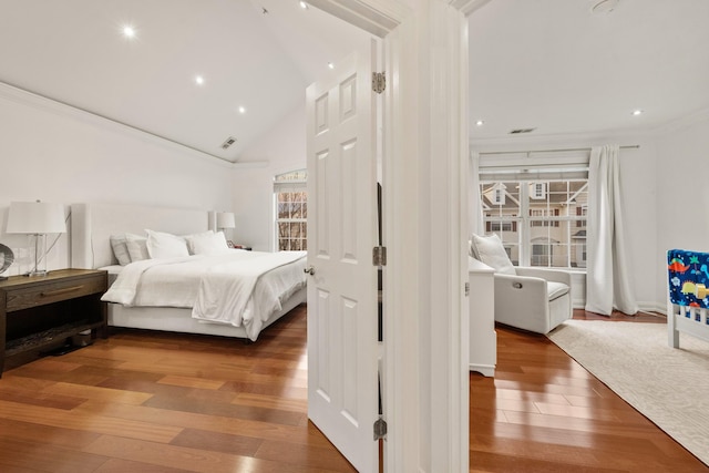 bedroom featuring visible vents, lofted ceiling, wood-type flooring, crown molding, and recessed lighting