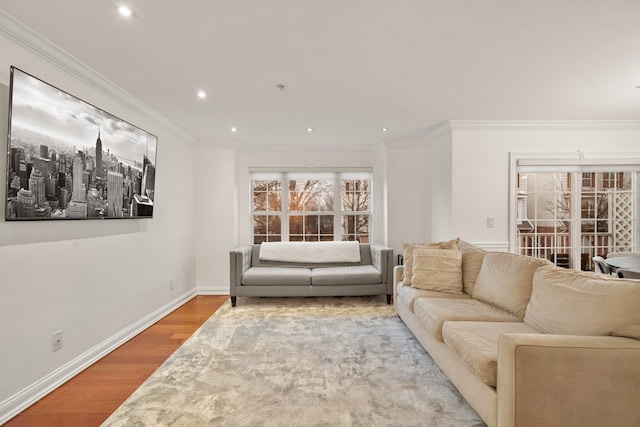 living room with ornamental molding, recessed lighting, wood finished floors, and baseboards