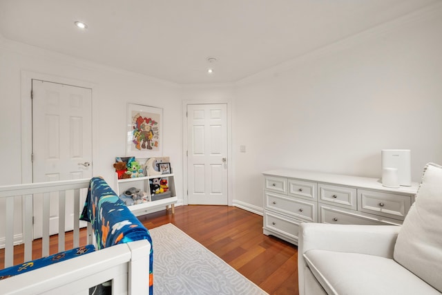 bedroom featuring dark wood-style floors, crown molding, and recessed lighting