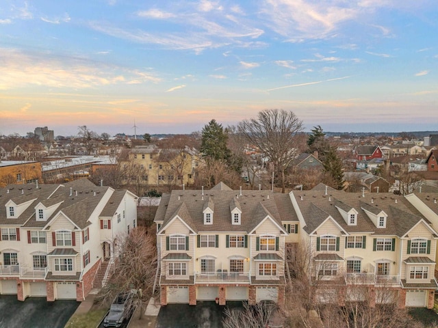 aerial view at dusk featuring a residential view