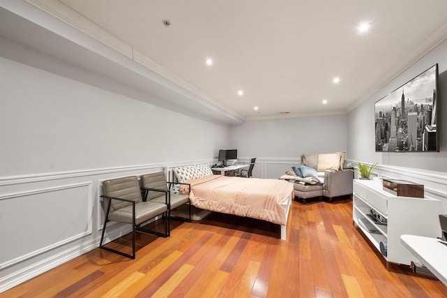 bedroom featuring ornamental molding, wainscoting, recessed lighting, and light wood-style floors